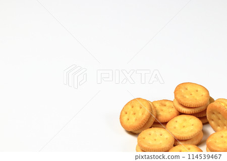 Pile of ready made Round cookies cracker with cheese or cheesy crackers isolated on white background. 114539467
