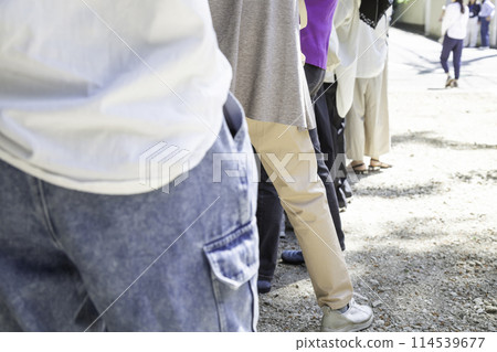 Procession of people waiting for their turn Back view 114539677