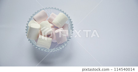 Fluffy white marshmallow macro isolated over white background. Fluffy white marshmallow macro isolated over white background. 114540014
