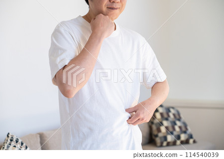 A man pinching his subcutaneous fat and smiling A man pinching his subcutaneous fat and smiling 114540039