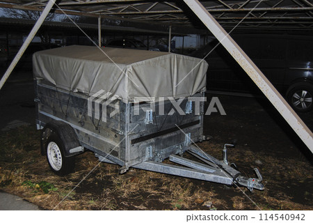 tilt trailer.Tall curtain trailer, two-axle, gray. tilt trailer.Tall curtain trailer, two-axle, gray. 114540942