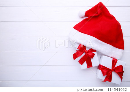 Santa Claus red hat and gifts on white background 114541032