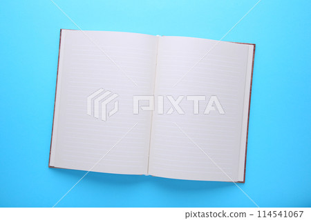 Notebook on a blue background, close up 114541067