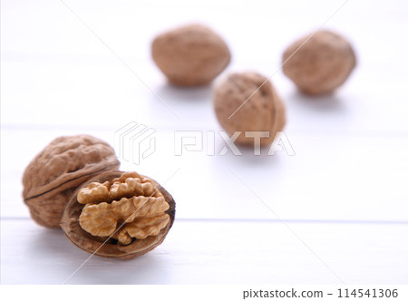 Walnuts kernels on white wooden background. Walnut healthy food 114541306