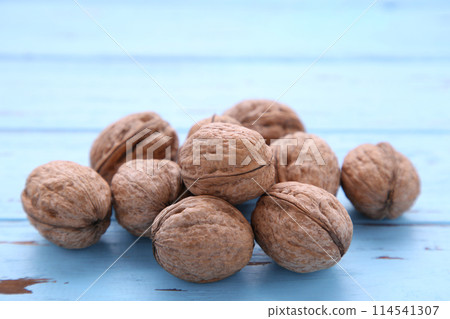 Walnuts kernels on blue wooden background. Walnut healthy food Walnuts kernels on blue wooden background. Walnut healthy food 114541307