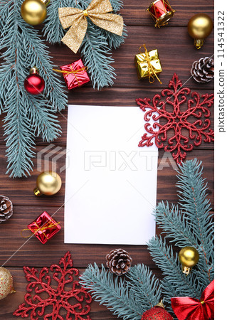 Christmas composition. Fir branches and christmas decor on a brown background Christmas composition. Fir branches and christmas decor on a brown background 114541322