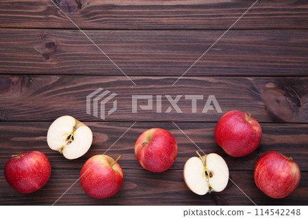 Fresh red apples on a brown wooden background 114542248