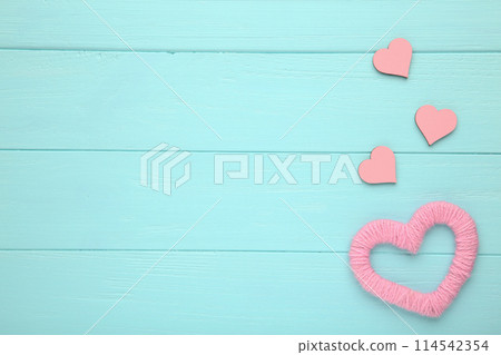 Red thread hearts on a blue background. Pink hearts 114542354