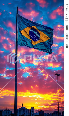 vibrant flag of Brazil dances in the sky as the sun sets, symbolizing strength, unity, and patriotism. 114542695