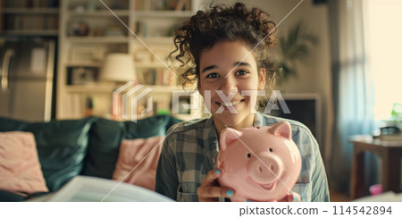 A person holding a piggy bank with a smiling expression 114542894