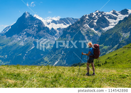 Sporty woman hiking in Switzerland alps. Heathy lifestyle, sport, beauty in nature. Grindelwald valley, Swizz 114542898