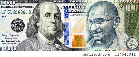 Portraits of Benjamin Franklin on banknote american dollars and Mahatma  Gandhi on Indian rupees. Business concept 114543011