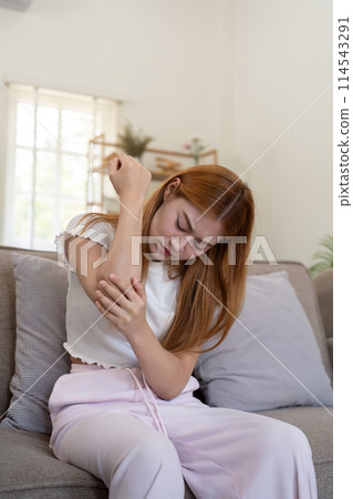 Asian woman have elbow pain, inflammation of tendon or ligament injury, overuse of arm muscles, Sore elbow or symptoms of rheumatoid arthritis Asian woman have elbow pain, inflammation of tendon or ligament injury, overuse of arm muscles, Sore elbow or symptoms of rheumatoid arthritis 114543291