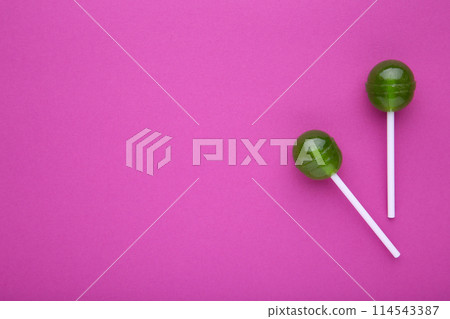 Green lollipops on pink background. sweet candy concept 114543387