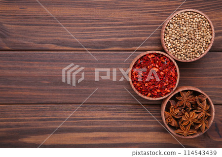 Spices mix on a brown wooden background. Top view Spices mix on a brown wooden background. Top view 114543439