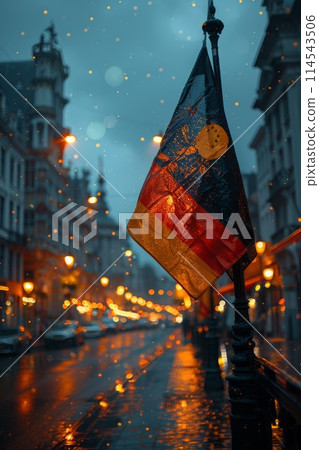 vibrant German flag flies proudly in the rain on a city street, its colors vivid against the grey backdrop. vibrant German flag flies proudly in the rain on a city street, its colors vivid against the grey backdrop. 114543506