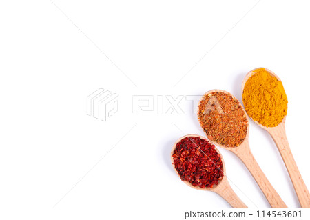 Spices mix on wooden spoons on a white wooden background. Top view Spices mix on wooden spoons on a white wooden background. Top view 114543601