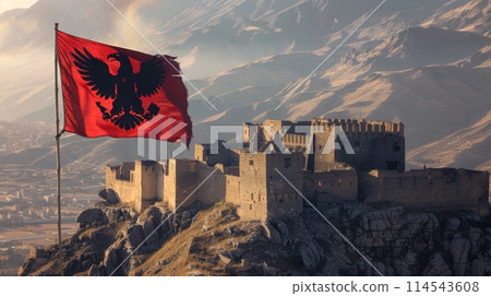 red flag with a black double-headed eagle symbol of Albania waving proudly at the summit of a towering mountain. red flag with a black double-headed eagle symbol of Albania waving proudly at the summit of a towering mountain. 114543608