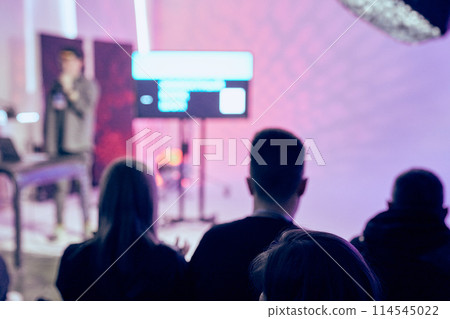 The student audience is in the conference room, listening to the speaker on a blurred background with a bokeh effect. The concept of a seminar, event, education with a copy space. High quality photo 114545022