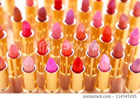 Many colorful lipstick on beige background, close up Many colorful lipstick on beige background, close up 114545295