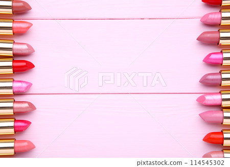 Many colorful lipsticks on beige background, flat lay 114545302