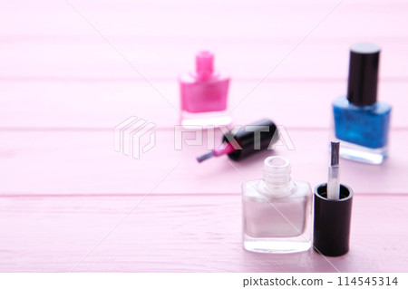 Group of bright nail polishes on pink 114545314