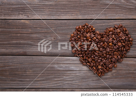 Coffee beans in shape of heart on grey background Coffee beans in shape of heart on grey background 114545333