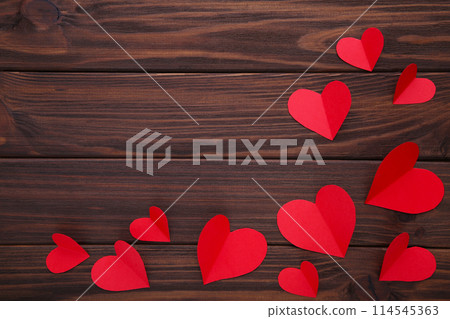 Valentines day greeting card. Handmaded red hearts on brown background. 114545363