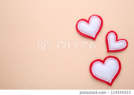 Valentines day greeting card. Handmaded hearts on beige background. Valentines day greeting card. Handmaded hearts on beige background. 114545913
