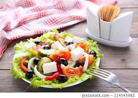 Fresh vegetable salad on grey wooden background 114545992