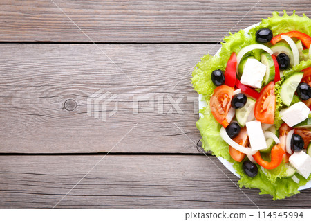 Fresh greek salad on grey wooden background 114545994