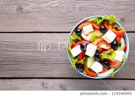 Fresh vegetable salad on grey wooden background Fresh vegetable salad on grey wooden background 114546003