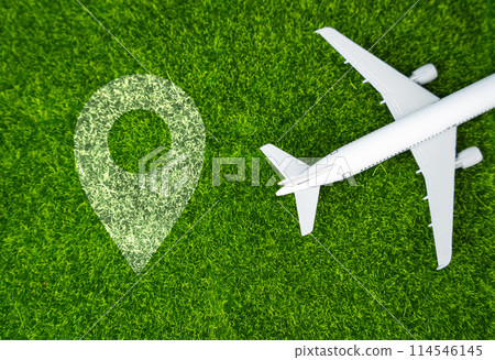 Airplane and geolocation sign on the grass. Travel and business trips. Transport system and infrastructure. Air communication. World flight routes. 114546145