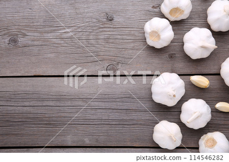 Fresh garlic on a grey wooden background Fresh garlic on a grey wooden background 114546282