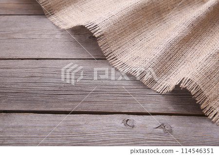 Natural sackcloth on grey wooden background. Canvas on grey wooden table 114546351