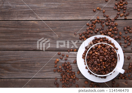 Coffee beans in cup on grey wooden background. 114546470