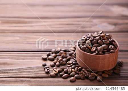 Coffee beans in wood bowl on brown background. 114546485