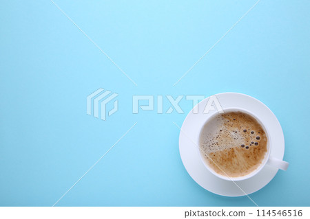 Cup of coffee on blue background, flat lay 114546516