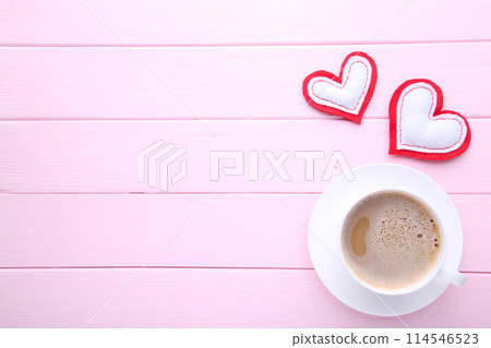 Valentine's day background. Cups of coffee with hearts on pink table Valentine's day background. Cups of coffee with hearts on pink table 114546523