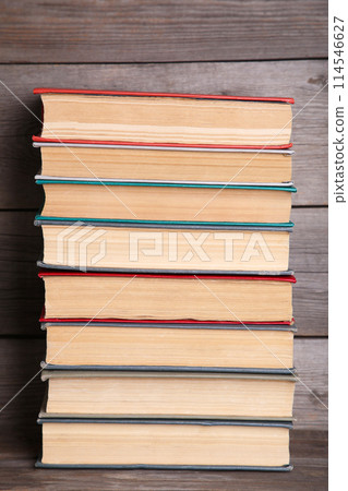 Old vintage books on grey wooden table 114546627