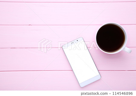 Smart phone with cup of coffee on pink wooden background Smart phone with cup of coffee on pink wooden background 114546896