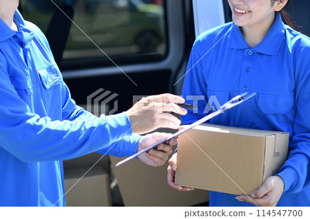 Male and female driver workers having a conversation outdoors Male and female driver workers having a conversation outdoors 114547700
