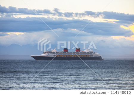 Large cruise ship passing by at sunset 114548010