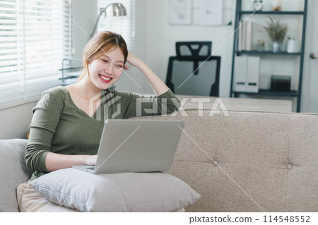 Young woman working on laptop at home during the day. Work life balance concept Young woman working on laptop at home during the day. Work life balance concept 114548552