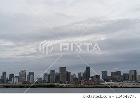 Buildings spread out under a cloudy sky Buildings spread out under a cloudy sky 114548773