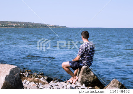 The young man relaxing on the beach The young man relaxing on the beach 114549492