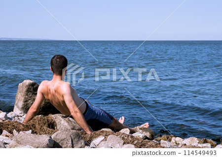The young man relaxing on the beach The young man relaxing on the beach 114549493