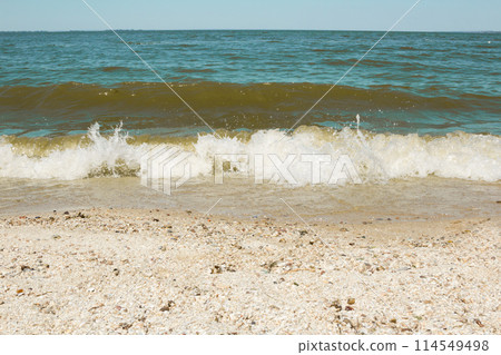 Sea wave on a sandy beach Sea wave on a sandy beach 114549498
