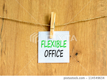 Flexible office symbol. Concept words Flexible office on beautiful white paper on wooden clothespin. Beautiful wooden background. Business Flexible office concept. Copy space. Flexible office symbol. Concept words Flexible office on beautiful white paper on wooden clothespin. Beautiful wooden background. Business Flexible office concept. Copy space. 114549634