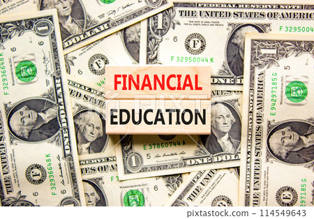 Financial education symbol. Concept words Financial education on beautiful wooden block. Beautiful dollar bills background. Dollar bills. Business Financial education concept. Copy space. 114549643